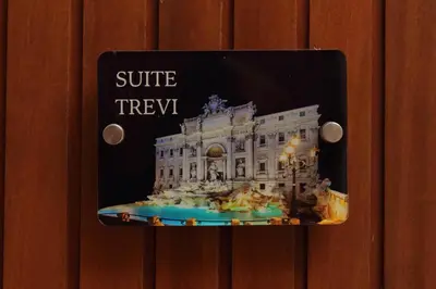 a light switch with a picture of a white building at Vatican Rooms Mura Aurelie in Rome