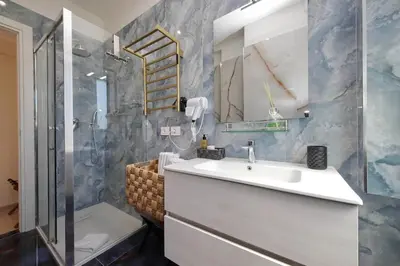 a bathroom with a sink and a shower at Vatican Rooms Mura Aurelie in Rome