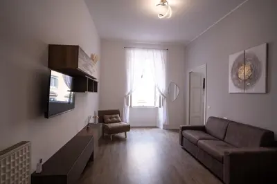 a living room with a couch and a chair at VT Cola di Rienzo Elegant Suites in Rome