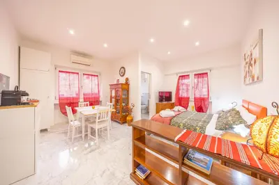 a bedroom with a bed and a kitchen with a table at vaticanloft for you in Rome