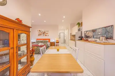 a kitchen with a table in the middle of a room at vaticanloft for you in Rome
