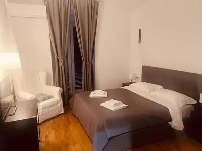 a bedroom with a bed and a television and a window at B&B Lorenzo 7HillsRoma in Rome
