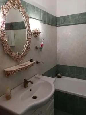 a bathroom with a sink and a mirror and a tub at stella condo in Rome