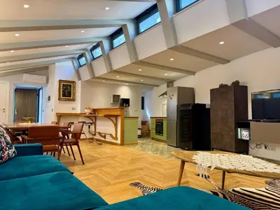 a living room with a blue couch and a table at Caracalla Loft in Rome