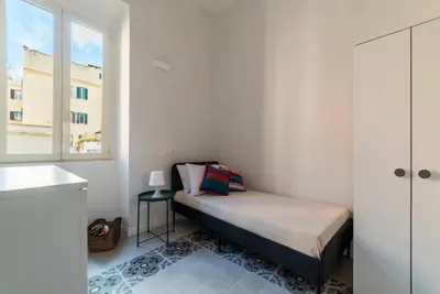 a small bedroom with a bed and a window at Dante's View - Pretty Homes in Rome