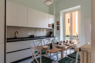 a kitchen with a table with chairs and a sink at Dante's View - Pretty Homes in Rome