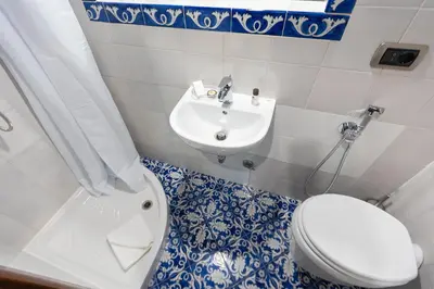 a bathroom with a toilet and a sink at Amazing Apartment Trastevere in Rome