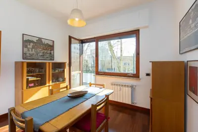 a dining room with a table and a large window at Amazing Apartment Trastevere in Rome