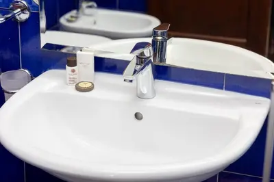 a bathroom sink with a faucet and a mirror at Amazing Apartment Trastevere in Rome