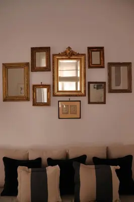 a living room with a couch with mirrors on the wall at Casa Romantica in Rome