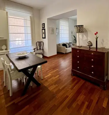 a living room with a table and a dresser at Casa Romantica in Rome