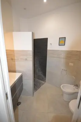 a bathroom with a shower and a toilet and a sink at San Remo Apartment in Rome