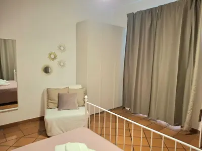 a room with a bed and a couch and a window at Candia 66 at the Vatican Museums in Rome