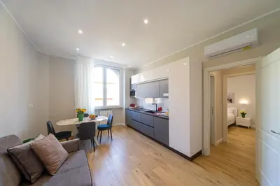 a kitchen and living room with a couch and a table at Palumbo 12 Holiday Home in Rome