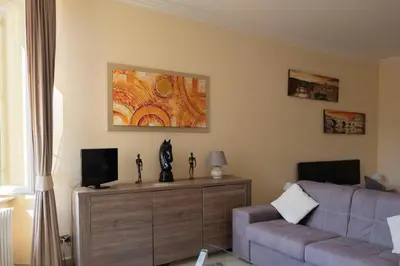a living room with a couch and a tv at Sistina Apartment in Rome