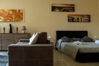 a bedroom with a bed and a chair in it at Sistina Apartment in Rome