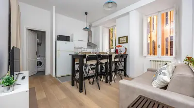 a living room with a couch and a kitchen with a table at Casa Maria Teresa by Rentbeat in Rome
