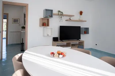 a white table in a living room with a bowl of fruit at Domus Blu Aurelia in Rome