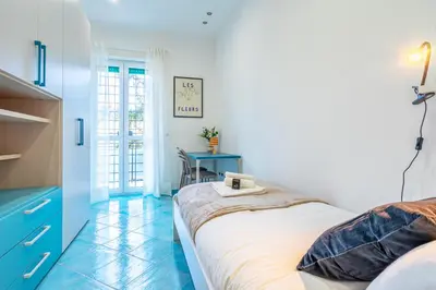 a bedroom with a bed and a blue table at Domus Blu Aurelia in Rome