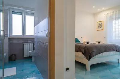 a bedroom with a bed and a bathroom at Domus Blu Aurelia in Rome