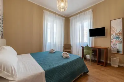 a living room with a tv and a couch at GuestHost - San Giovanni Laterano Apartment in Rome