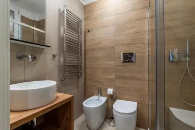 a bedroom with a large bed with towels on it at GuestHost - San Giovanni Laterano Apartment in Rome