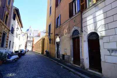 a cobblestone street in an alley with buildings at Elegant Suite Colosseo in Rome