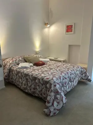 a bedroom with a large bed in a room at Trecento7Flat in Rome