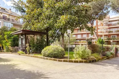 a park with a gazebo in front of a building at La Piccola Luxury Suite in Rome
