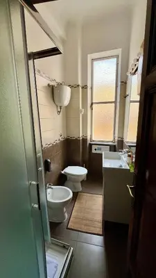a small bathroom with a toilet and a sink at Casa Domenica in Rome