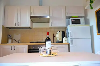a kitchen with a bottle of wine on a counter at Gianicolo Trastevere Exclusive Apartments in Rome
