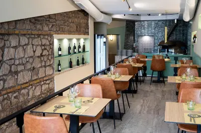 a restaurant with tables and chairs and wine bottles on the wall at San Lorenzo Accommodation One in Rome