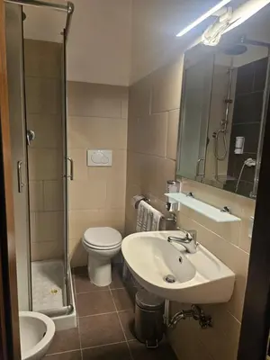 a bathroom with a sink and a toilet and a shower at San Lorenzo Accommodation One in Rome