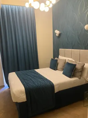 a bedroom with a large bed with blue curtains at Esquilino rooms in Rome