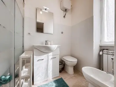 a white bathroom with a sink and a toilet at Domus Valle Aurelia - Vaticano - Metro Linea A in Rome