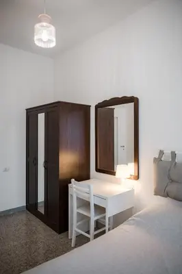 a bedroom with a desk and a mirror and a bed at Domus Valle Aurelia - Vaticano - Metro Linea A in Rome