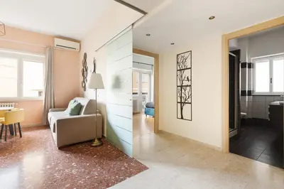 a living room with a couch and a table at Monteverde Private Terrace in Rome