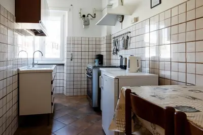 a small kitchen with a sink and a stove at AnnaMarco Apartment in Rome