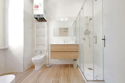 a bathroom with a toilet and a sink and a shower at 4BNB - Stylish Spacious Apartment near Vatican in Rome