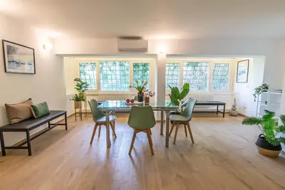 a living room with a dining room table and chairs at 94Rooms Roma Nord - Flaminia in Rome