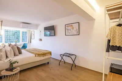 a white bedroom with a bed and a window at 94Rooms Roma Nord - Flaminia in Rome