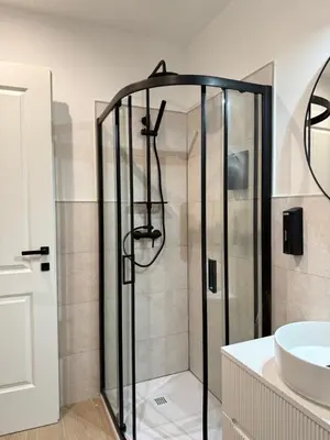 a bathroom with a shower and a sink at Vita Lux Vatican Suites in Rome