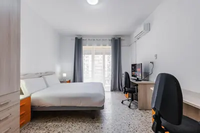 a bedroom with a bed and a desk with a computer at Veturia in Rome