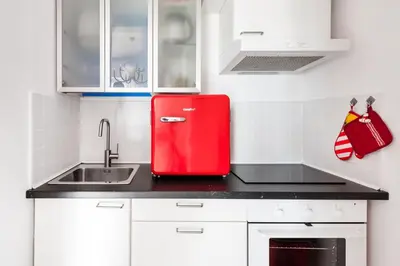 a red refrigerator in a kitchen with a sink at Cielo di Roma con Terrazzo - Self Check-in 24h in Rome