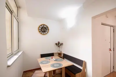 a dining room with a table and a clock on the wall at HC - Stadio Olimpico Huge Apartment NEW in Rome