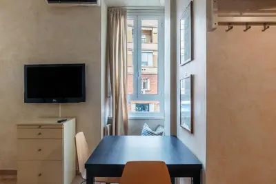 a living room with a couch and a wooden door at GuestHost - Roma Tiburtina Apartment in Rome