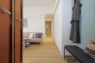a hallway leading to a living room with a couch at YCH-Eleganza e confort vicino metro re di Roma in Rome