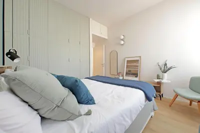 a bedroom with a bed with blue and white pillows at YCH-Eleganza e confort vicino metro re di Roma in Rome