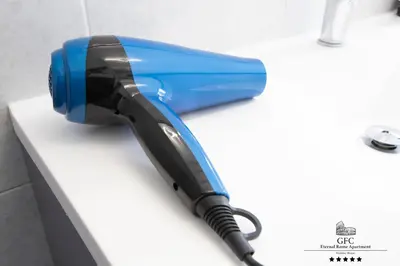 a blue and black hair dryer sitting on a counter at GFC Eternal Rome Apartment - 5min to Tiburtina Station MetroB, 2 Bathrooms, Terrace, A-C in Rome