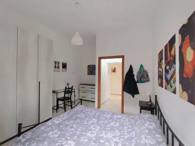 a bedroom with a bed and a desk in a room at Casa del Vinile Roma in Rome